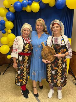 Three women in traditional Ukrainian dress posing together