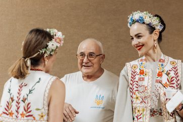 Guests in floral crowns greeting each other